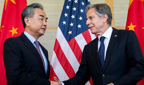 Chinese diplomat Wang Yi with US Secretary of State Antony Blinken in Bali on July 9, 2022 (AFP)