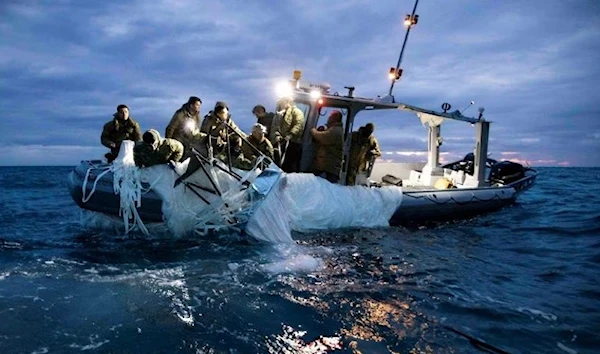 Sailors recover the suspected Chinese high-altitude balloon that was downed by the US, Feb.5, 2023. (Reuters)