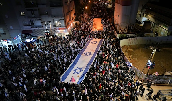 Israelis march during a protest against plans by Prime Minister Benjamin Netanyahu's new government to overhaul the judicial system, in Tel Aviv, Israel, February 18, 2023. (AP/Tsafrir Abayov)