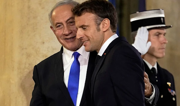 French president Emmanuel Macron, welcomes Israeli occupaton Prime Minister Benjamin Netanyahu prior to their meeting at the Elysee Palace, in Paris, France, Thursday, Feb. 2, 2023 (AP Photo)