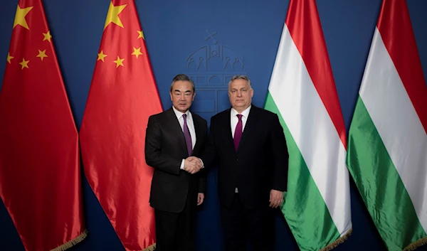 Hungarian Prime Minister Viktor Orban receives China's Director of the Office of the Central Foreign Affairs Commission Wang Yi during a private dinner in Hungary, February 19, 2023 (Hungary PM office via AP)