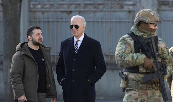 President Joe Biden, center, and Ukrainian President Volodymyr Zelenskyy talk during an unannounced visit in Kyiv, Ukraine, Monday, Feb. 20, 2023 (Ukrainian Presidential Press Office via AP)