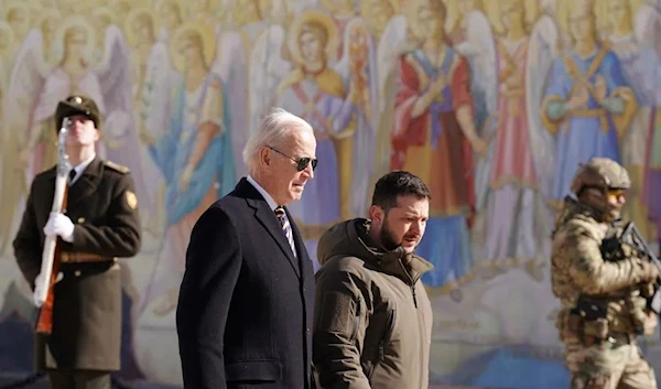 US President Joe Biden and Ukrainian President Volodymyr Zelensky walking in Kiev on February 20, 2023 (AFP)