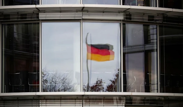 A German flag is reflected in the window of the Paul Loebe building in Berlin, Germany, November 19, 2020 (Reuters).