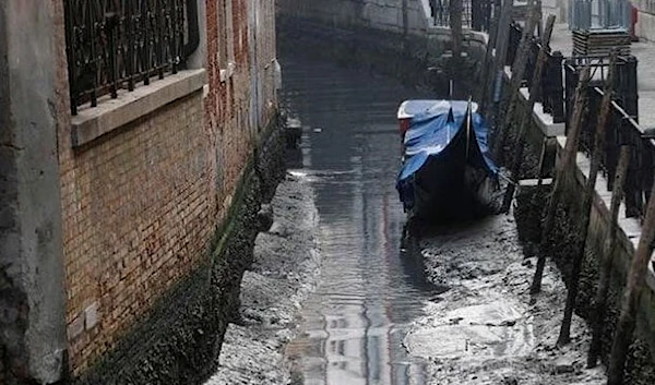 A gondola is pictured in a canal during a severe low tide in the lagoon city of Venice, Italy, February 17, 2023. (Reuters)