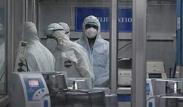 Technicians wearing personal protective equipment suits are seen inside a molecular laboratory facility set up to test for the mpox during its inauguration at the King Institute in Chennai. (AFP)