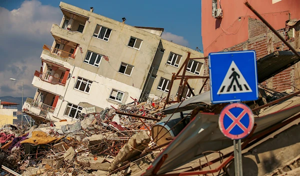 A destroyed building leans on a neighbouring house following the earthquake in Samandag, southern Turkey, Wednesday, Feb. 22, 2023 (AP).