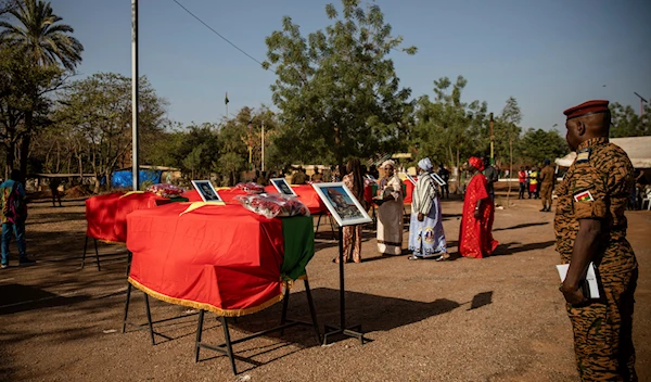 A military officer stands in front of the coffin containing the remains of Burkina Faso's revolutionary leader, Thomas Sankara, during his reburial ceremony in Ouagadougou, Burkina Faso, Thursday, Feb. 23, 2023 (AP).