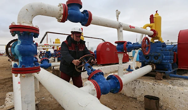 A worker checks the pressure of pumps at an oil-pumping station in the Uzen oil and gas field in the Mangistau Region of Kazakhstan November 13, 2021. (Reuters)