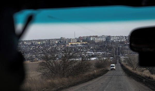 A car drives on the highway in Bakhmut, Friday, Feb. 24, 2023 (AP Photo/Evgeniy Maloletka)