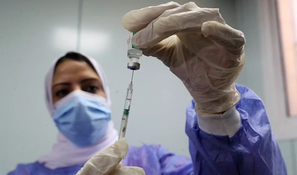 A healthcare worker holds a syringe and vaccine vial against the coronavirus disease (COVID-19) in Cairo, Egypt March 4, 2021. (Reuters)