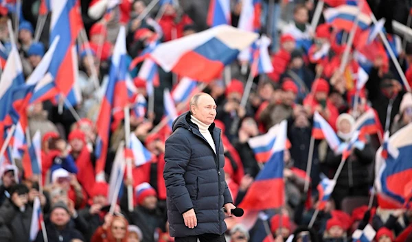 Russian President Vladimir Putin delivers a speech on the eighth anniversary of Russia's annexation of Crimea at Luzhniki Stadium in Moscow in March last year. | SPUTNIK / KREMLIN / VIA REUTERS