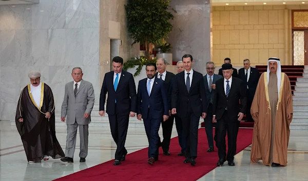 President Bashar al Assad walking with President al-Assad receives a delegation from the Arab Inter-Parliamentary Union. (Government of Syria)