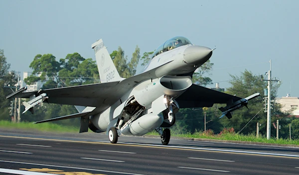 In this Sept. 16, 2014, photo, a Taiwan Air Force F-16 fighter jet lands on a closed section of highway (AP Photo/Wally Santana)