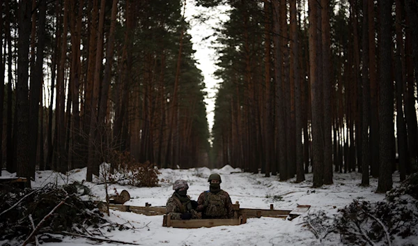 Ukrainian servicemen stand at a position close to the border with Belarus, Ukraine, Wednesday, Feb. 1, 2023 (AP Photo/Daniel Cole)