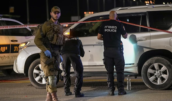 Israeli occupation forces examine the scene of a shooting operation near the West Bank city of Areeha, February 27, 2023 (AP Photo)