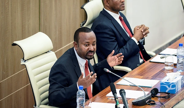 Ethiopia's Prime Minister Abiy Ahmed, left, accompanied by House speaker Tagesse Chafo, right, addresses the parliament in the capital Addis Ababa, Ethiopia Tuesday, Nov. 15, 2022 (AP Photo)