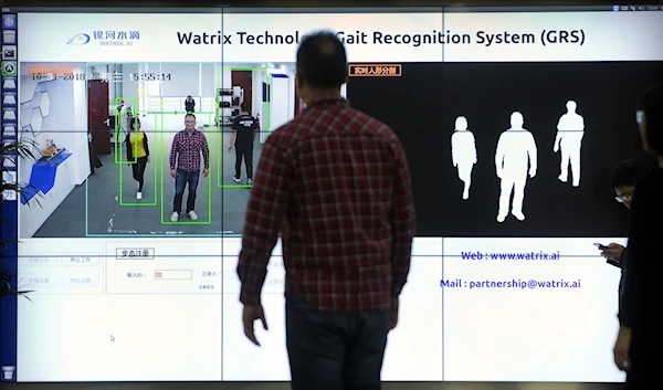 In this Oct. 31, 2018, photo, Watrix employees demonstrate their firm's gait recognition software at their company's offices in Beijing (AP Photo/Mark Schiefelbein)