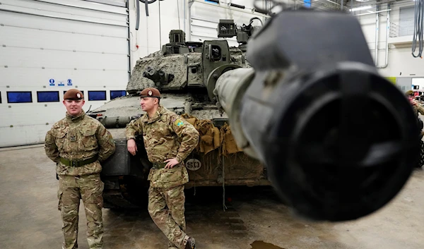 Britain's military officers stand next to a Challenger 2 tank at the Tapa Military Camp, in Estonia, Thursday, Jan. 19, 2023 (AP Photo/Pavel Golovkin)