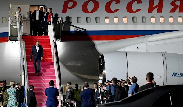 Russia's Foreign Minister Sergey Lavrov (center) arrives to attend the G20 Summit at Ngurah Rai International airport at Tuban, Badung regency in Bali, on November 13, 2022. (AFP/Sonny Tumbelaka)