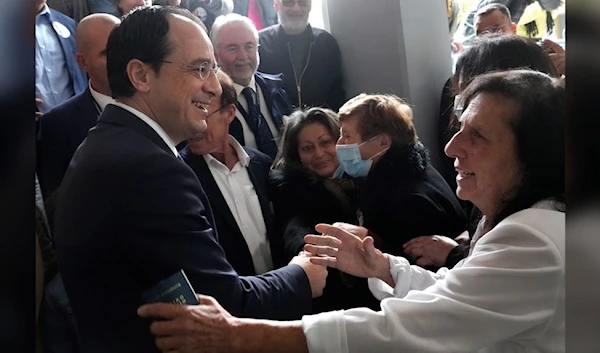 Presidential candidate and former foreign minister Nikos Christodoulides greets supporters after casting his vote in south west coastal city of Paphos, Cyprus, Sunday, Feb. 5, 2023.(AP)