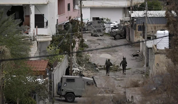 Israeli forces raid the Aqabat Jaber refugee camp southwest of the West Bank city of Jericho on Saturday.(AP)