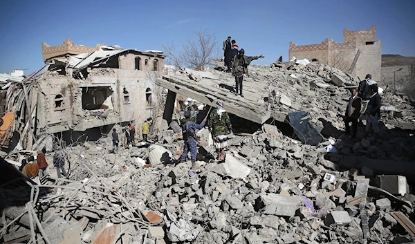 Yemenis inspect the wreckage of buildings after they were hit by Saudi-led coalition airstrikes, in Sanaa, Yemen, on Jan. 18, 2022. (AP)