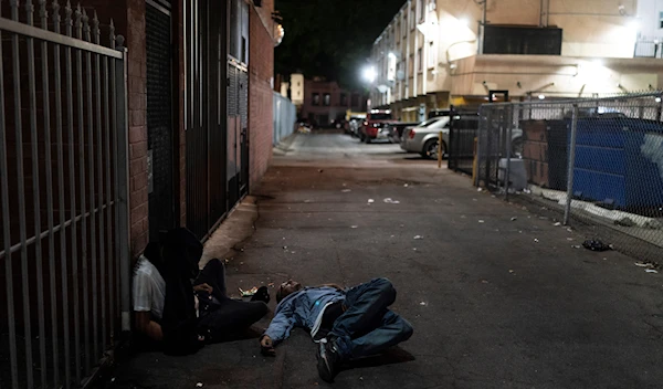 Two addicts sleep in an alley in Los Angeles, Wednesday, Sept. 21, 2022 (AP Photo/Jae C. Hong)