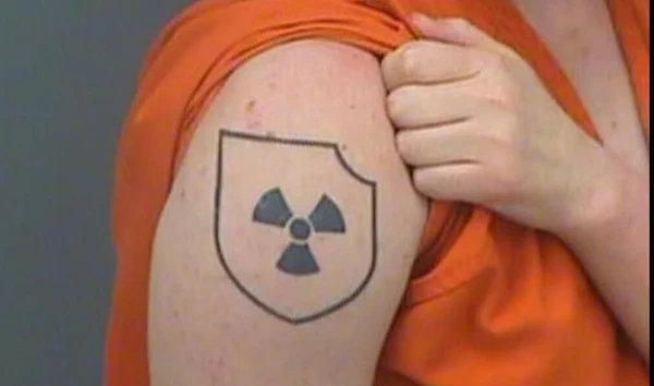 Brandon Russell, at the time a private first class in the Florida Army National Guard, displays his Atomwaffen tattoo after his May 2017 arrest for possessing bomb-making materials (Pinellas County Sheriff's Office).