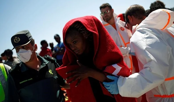 A migrant leaves a rescue boat after arriving at the port of Barbate, southern Spain, June 27, 2018 (REUTERS/Jon Nazca)