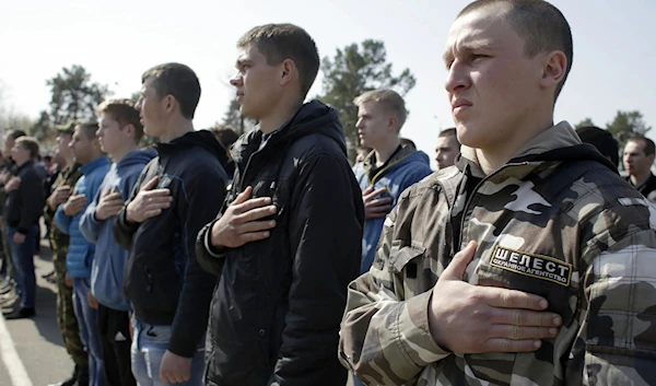 Ukrainian recruits singing the national anthem in April 2022 in Ukraine (AFP)