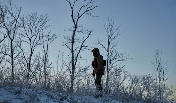 A Ukrainian soldier looks on in his position in the frontline close to Bakhmut, Donetsk region, Thursday, Feb. 9, 2023 (AP Photo/Libkos)