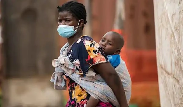 A child with cholera is being carried by his mother in central Malawi, on Jan. 11, 2023.  (AP)