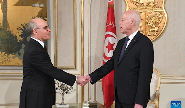 Tunisian President Kais Saied (R) shakes hands with Nabil Ammar during their meeting in Tunis, Tunisia, on Feb. 7, 2023. (Tunisian Presidency/Handout via Xinhua)