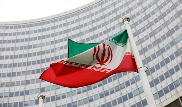 The Iranian flag waves in front of the International Atomic Energy Agency (IAEA) headquarters, in Vienna, Austria May 23, 2021. (Reuters)