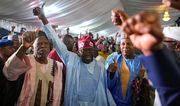 Bola Tinubu, center, of the All Progressives Congress celebrates with supporters at the Party's campaign headquarters after winning the presidential elections in Abuja, Nigeria, Wednesday, March 1, 2023. (AP)