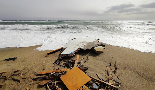 The wreckage from a capsized boat washes ashore at a beach near Cutro, southern Italy, Sunday, Feb. 26, 2023 (AP).