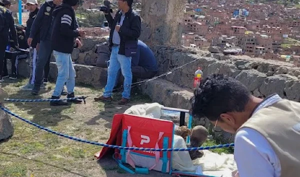 This handout picture  by Puno TV shows members of the Decentralized Directorate of Culture of Puno and the police investigating the discovery of a mummy inside a cooler box used by a delivery service worker in Puno (AFP)