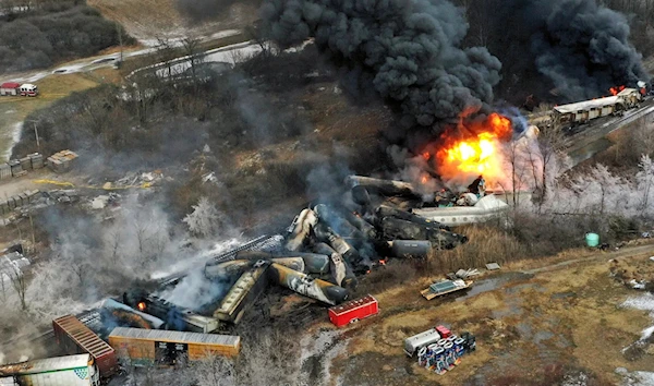 The Norfolk Southern freight train that derailed in East Palestine, Ohio, was still on fire at midday on Feb. 4, the day after the crash. (Associated Press)