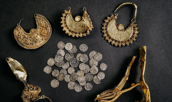 The Hoogwoud treasure includes four golden ear pendants, two strips of gold leaf, and 39 silver coins. (ARCHEOLOGY WEST-FRIESLAND/FLEUR SCHINNING)