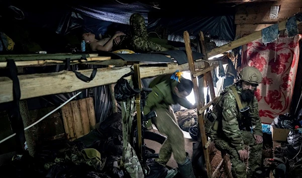 Ukrainian paratroopers of 80 Air Assault brigade rest inside a dugout at the frontline near Bakhmut, Friday, March 10, 2023 (AP Photo/Evgeniy Maloletka)