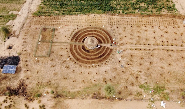 An aerial view shows participants of a Tolou Keur program working on a newly built Tolou Keur garden in Boki Diawe, within the Great Green Wall area, in Matam region, Senegal, July 10, 2021. (REUTERS)