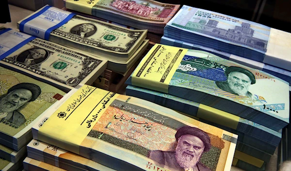 In this April 4, 2015 file photo, Iranian and U.S. banknotes are on display at a currency exchange shop in downtown Tehran, Iran (AP Photo/Vahid Salemi, File)