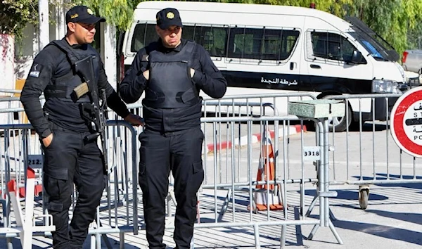 Tunisian police block the entrance to parliament as the new assembly holds its first session in Tunis. (AFP)