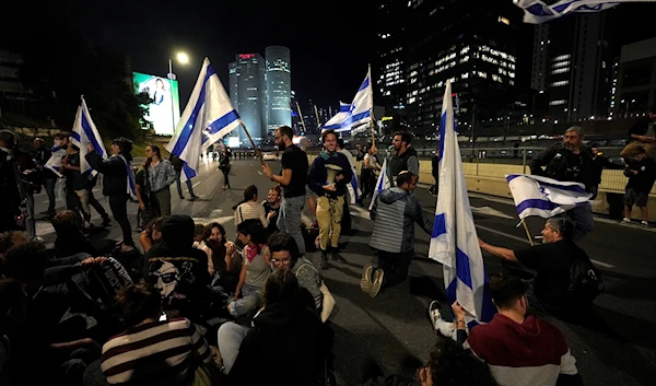 Israelis block a highway to protest plans by Prime Minister Benjamin Netanyahu's government to overhaul the judicial system, in Tel Aviv, Israel, Saturday, March 11, 2023. (AP)