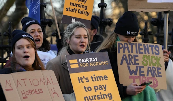 Nurses of the nearby St. Thomas' Hospital in central London stand on the picket line (AP)