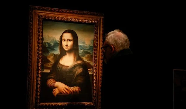 A visitor looks at a copy of the Leonardo da Vinci's Mona Lisa, which will go up for auction on November 9, at the Artcurial auction house in Paris, France, November 5, 2021. (REUTERS)