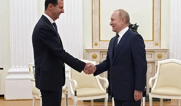 =Russian President Vladimir Putin shakes hands with Syrian President Bashar al-Assad during a meeting at the Kremlin in Moscow, Russia, September 13, 2021. (Reuters)