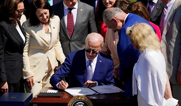 President Joe Biden signs into law H.R. 4346, the CHIPS and Science Act of 2022, at the White House in Washington, Aug. 9, 2022 (AP /Carolyn Kaster)