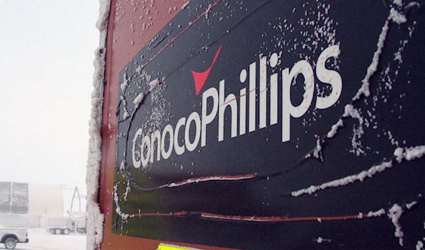 This Feb. 9, 2016, file photo shows an ice-covered ConocoPhillips sign at a drilling site in Nuiqsut, Alaska (AP Photo/Mark Thiessen, File)